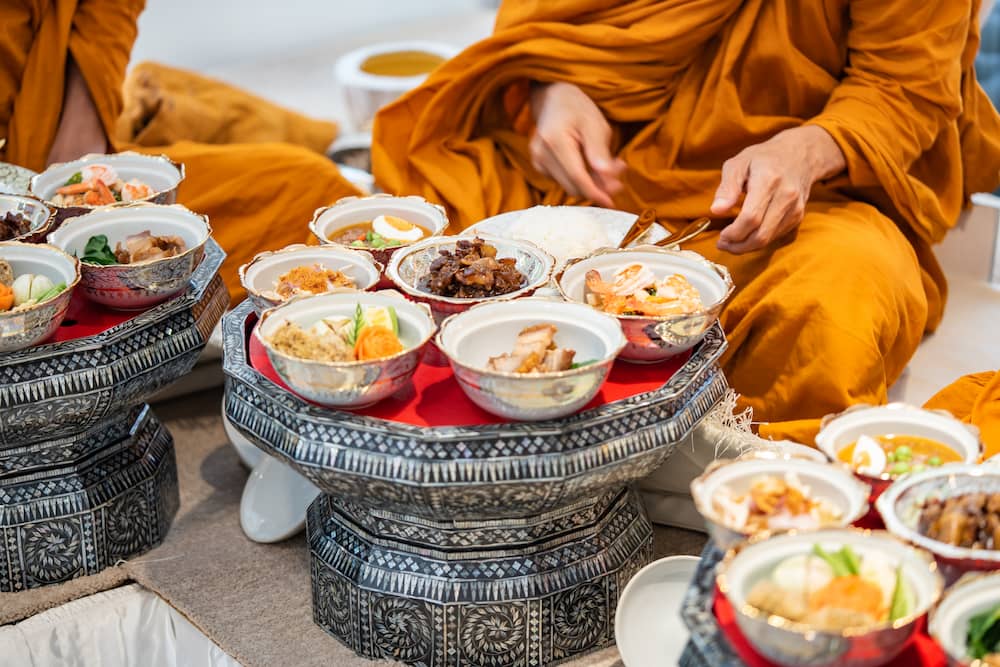 พระสงฆ์กำลังฉันอาหารในพิธีเลี้ยงพระขึ้นบ้านใหม่